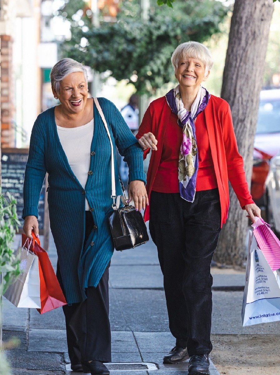 Two ladies walking together after shopping
