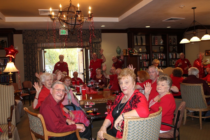 People in a dining room all wearing red