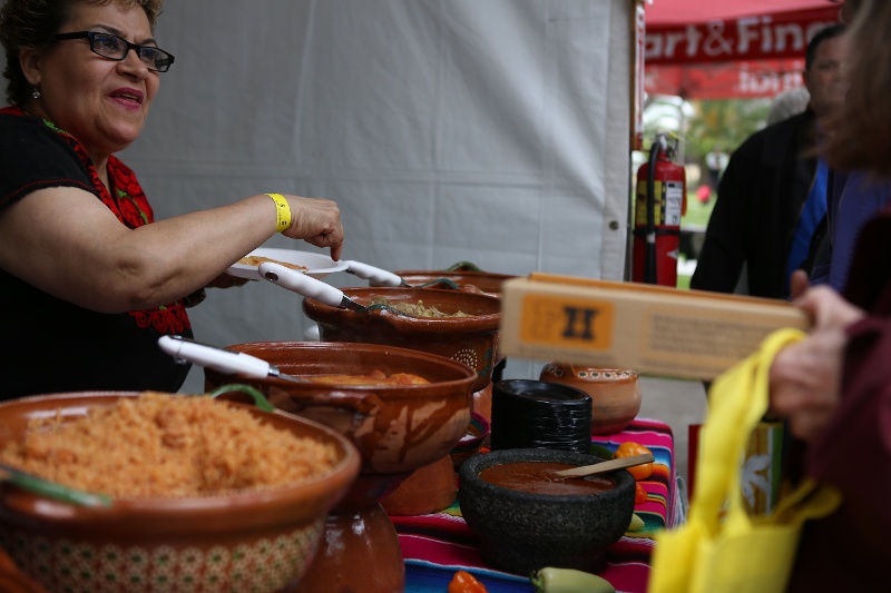 A woman making food in a booth