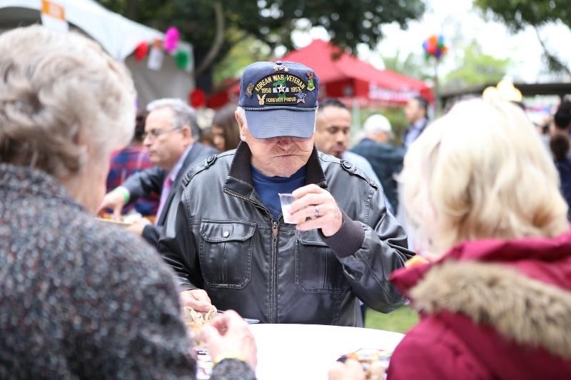 A man drink from a cup at a festival