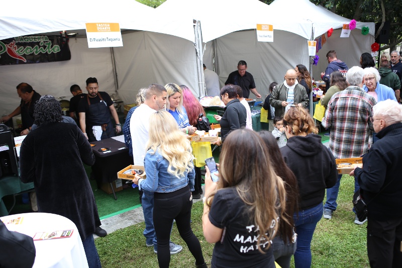 People walking between different festival booths.