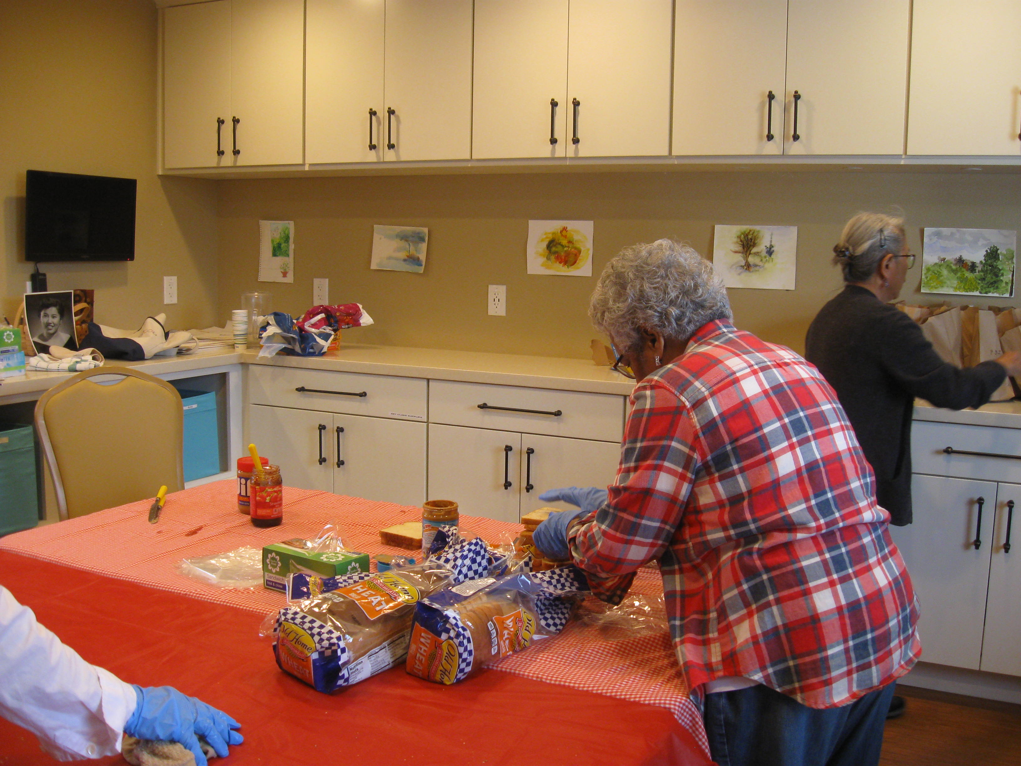 Residents pack lunches for the homeless