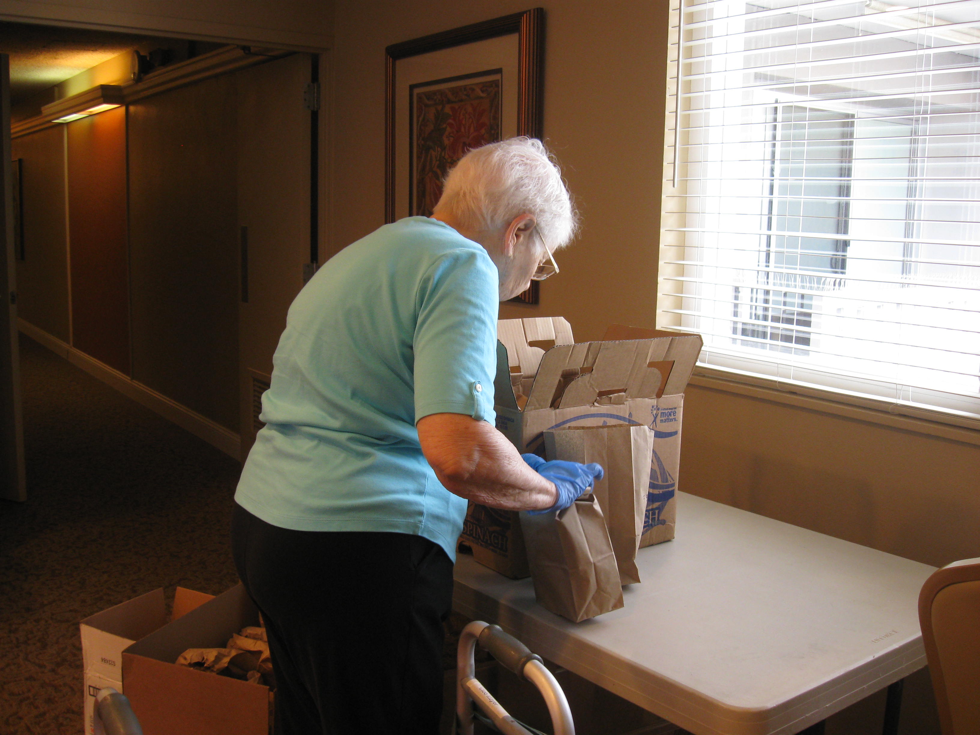 Residents pack lunches for the homeless