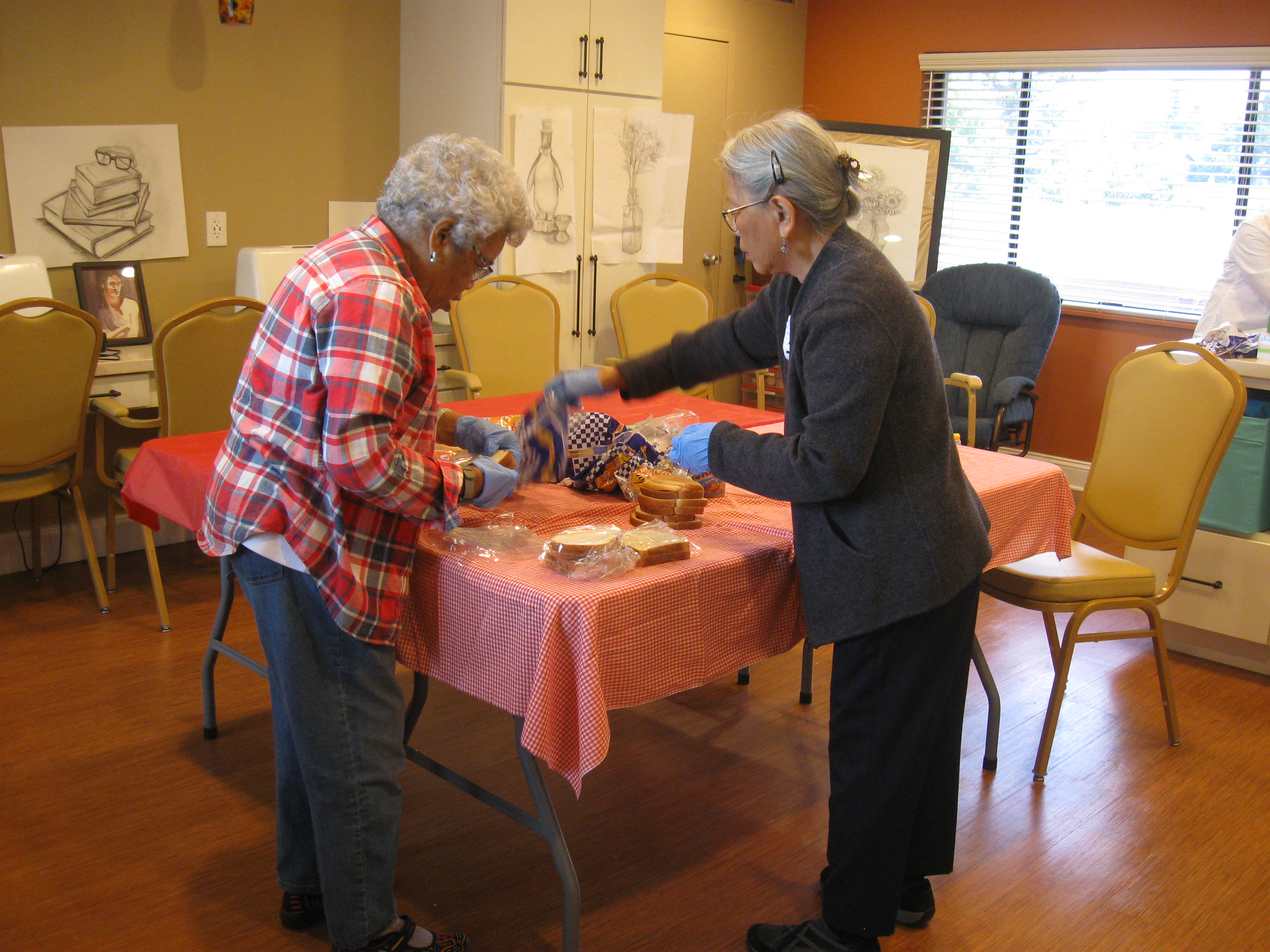 Residents pack lunches for the homeless