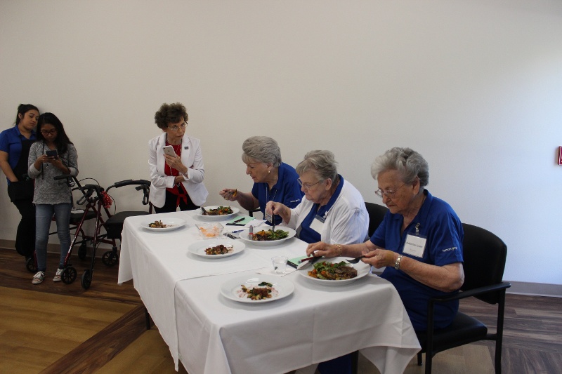 Three women eating at a table.