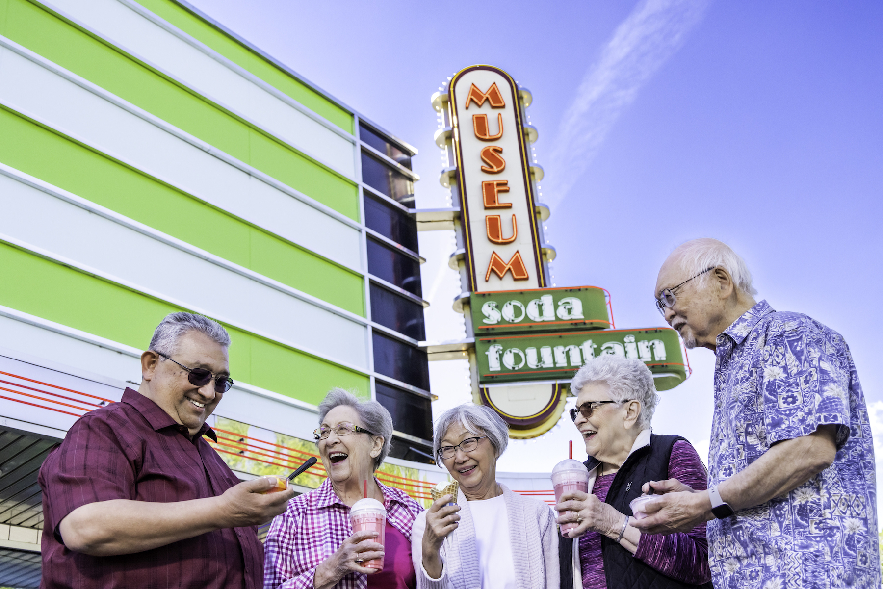 Group of friends in front of museum sign