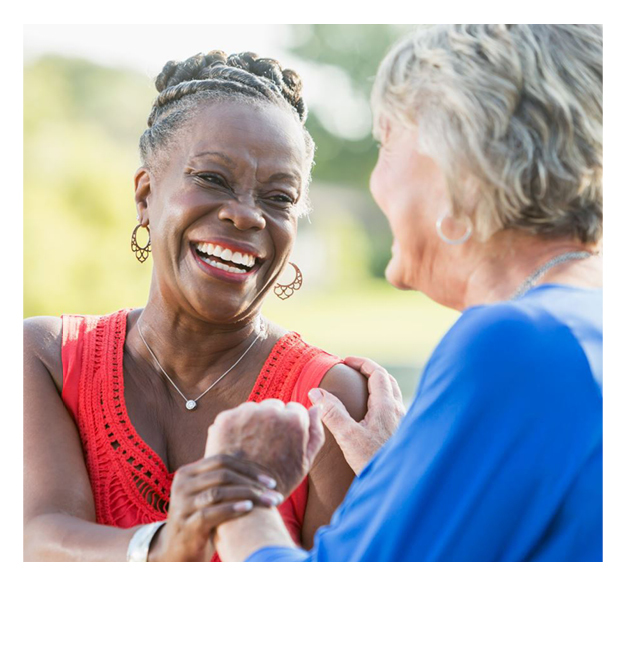 Two women, smiling and laughing.