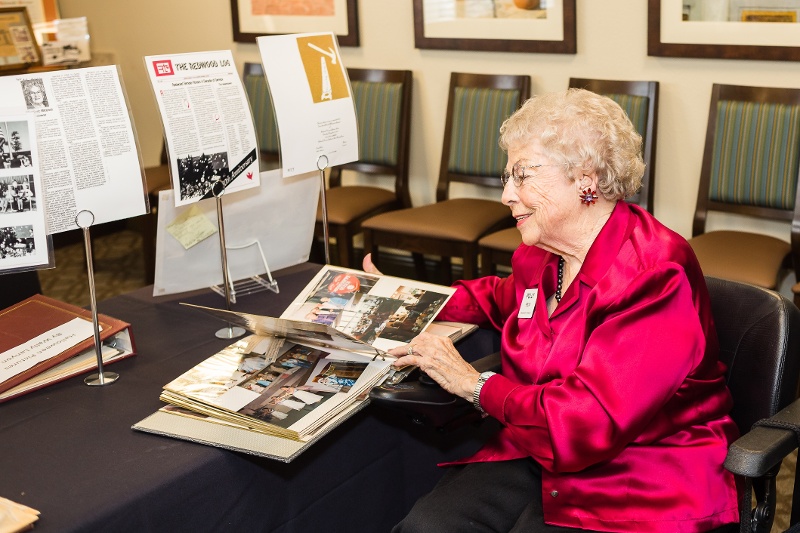 A woman looking at a photo album.