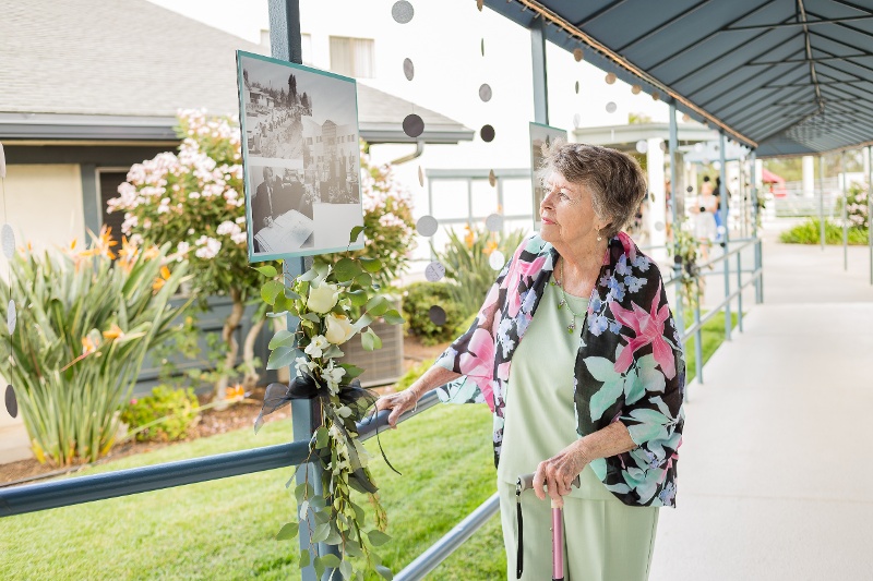 Woman on a path looking at a picture on a post