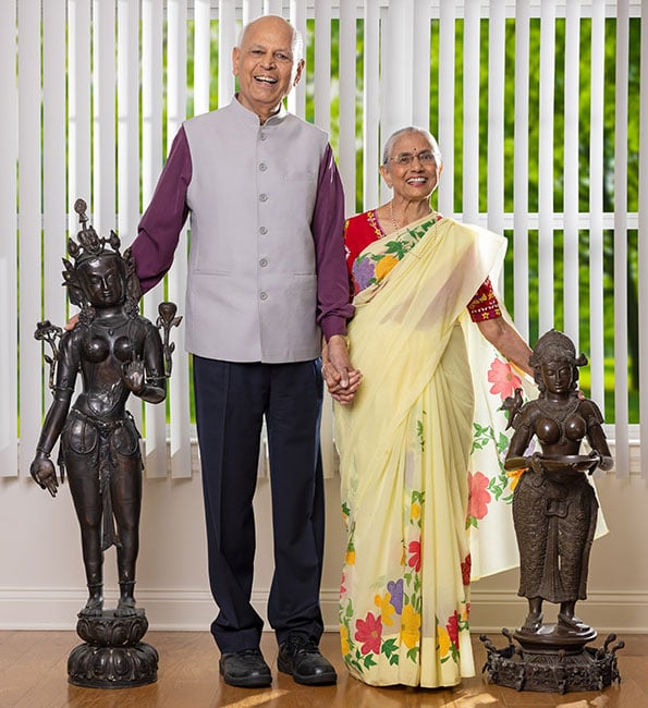 Haren and Pratima standing next to two sculptures