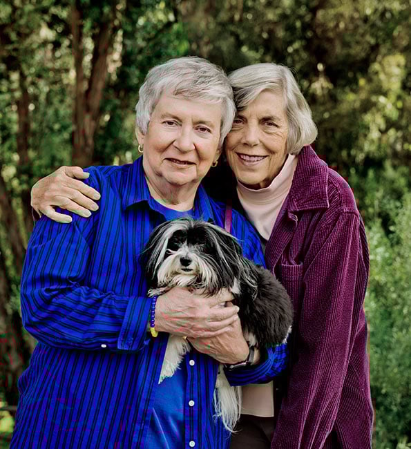 Jo Ann and Pat holding their Havanese dog, Darcy