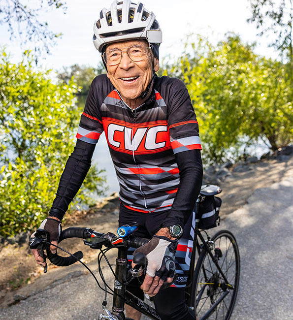 Louis wearing a bike helmet and on a bicycle