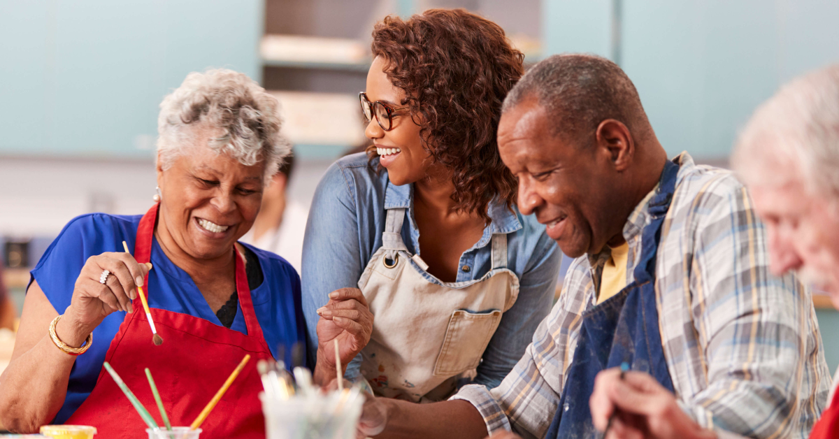 group of adult friends laughing at an art class