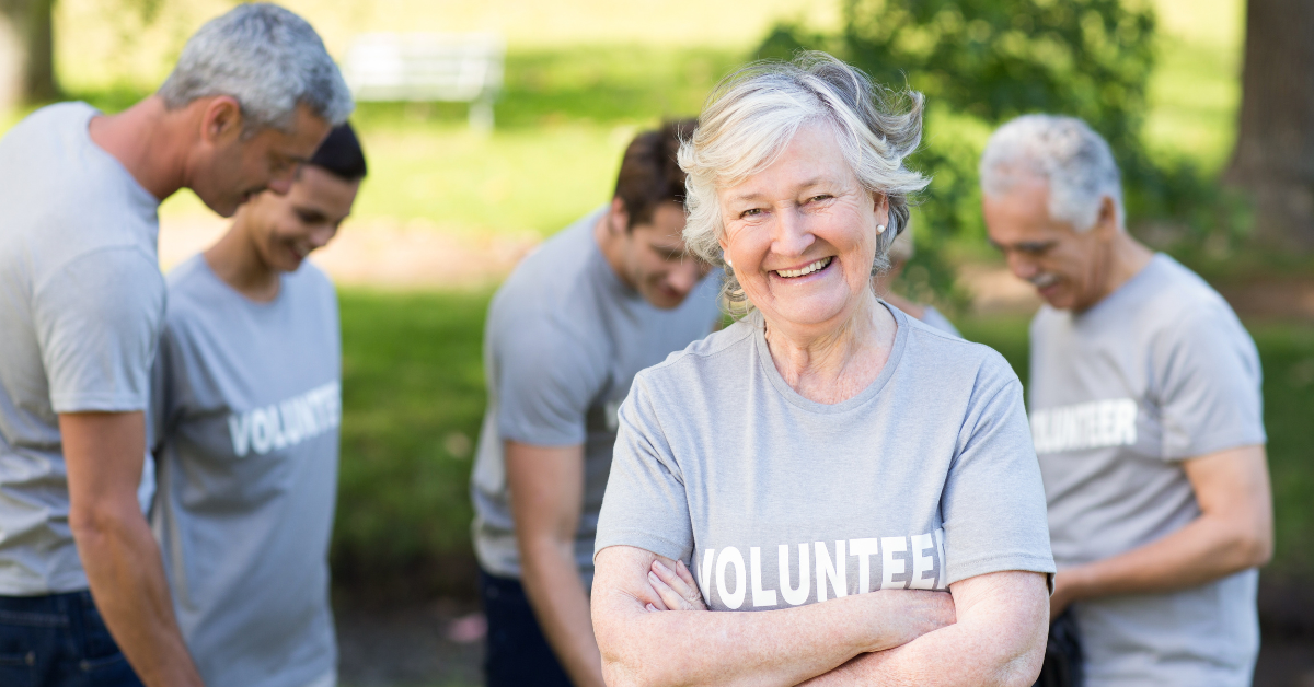woman smiling while volunteering outside 