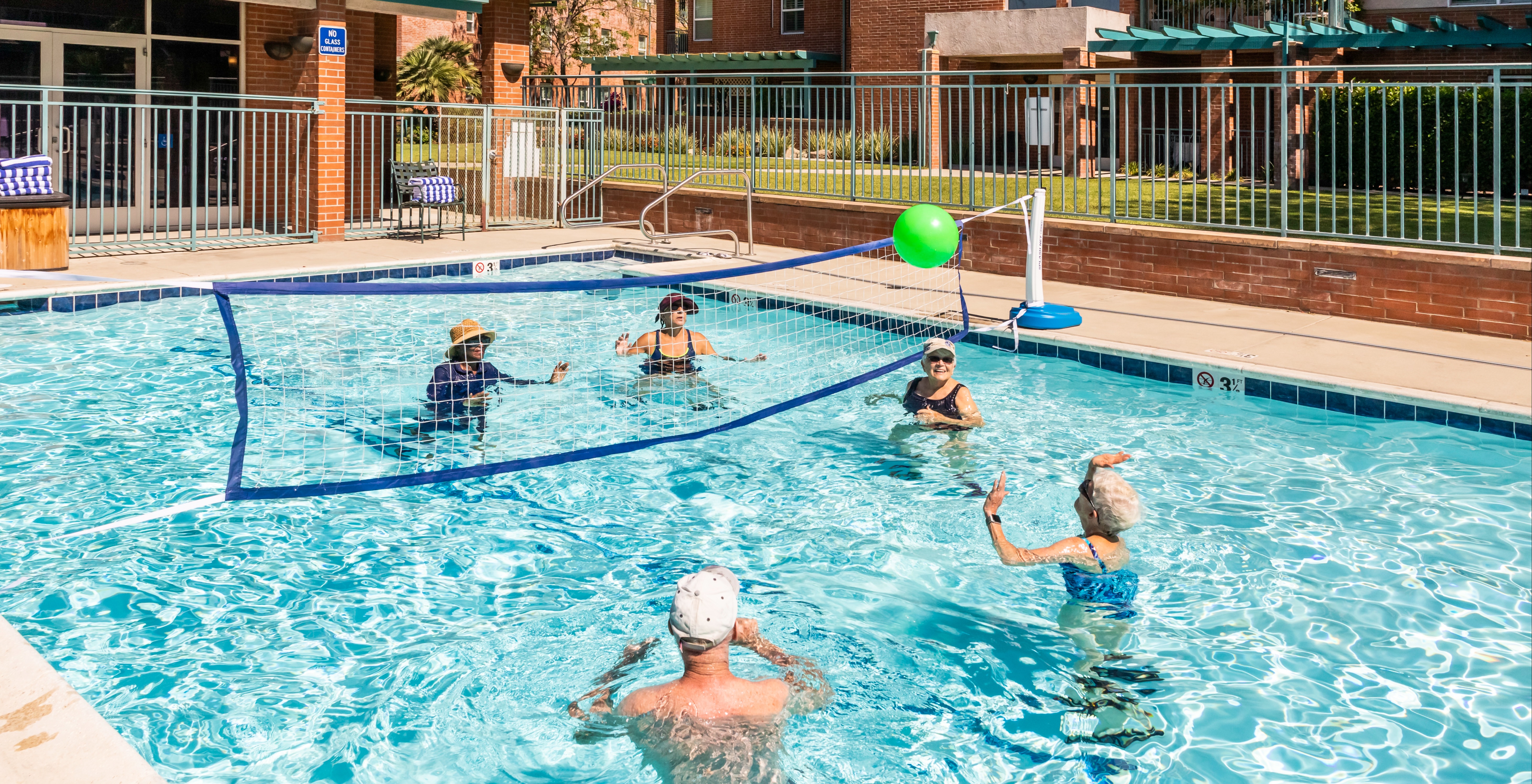 older adults playing pool volleyball