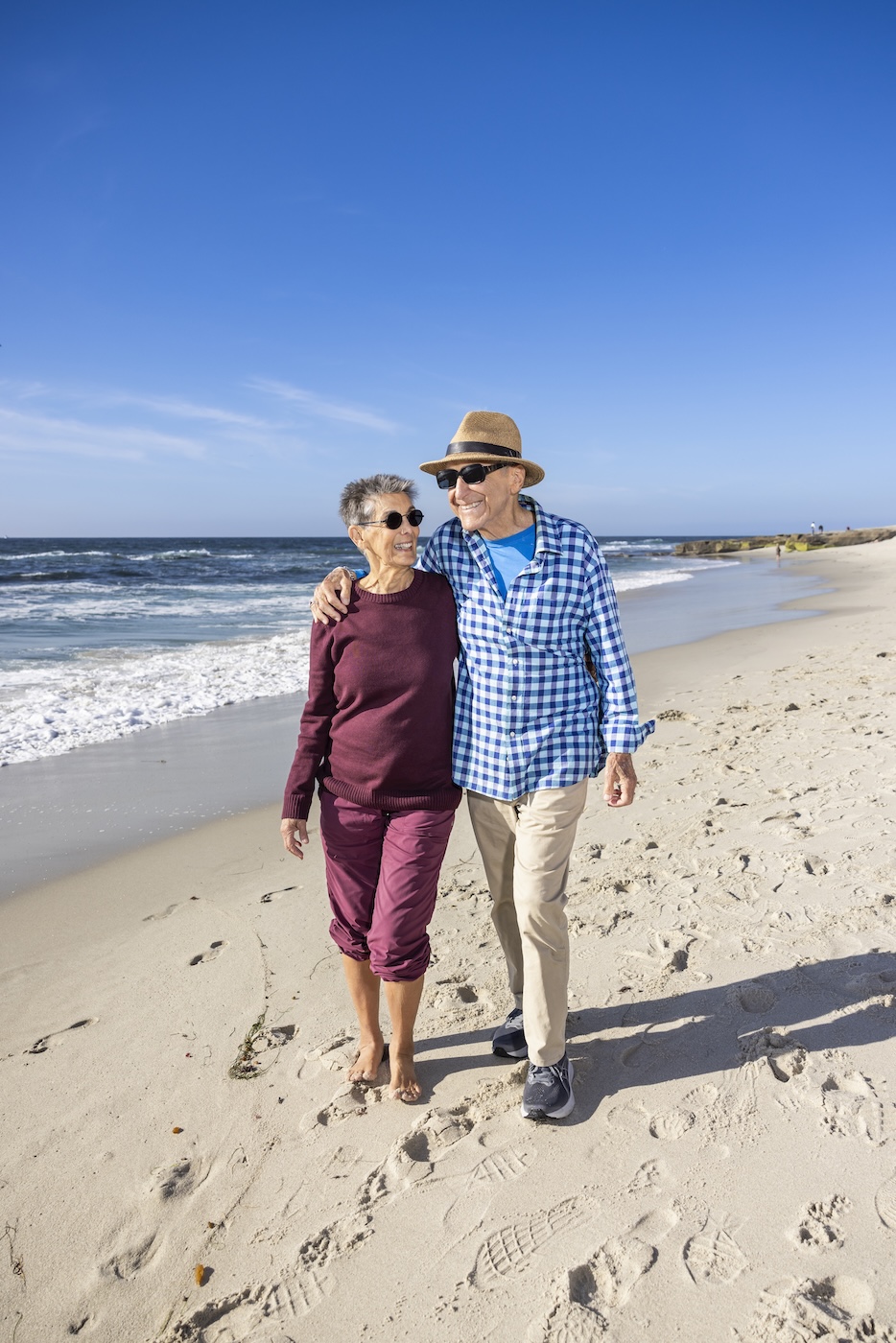 Marilyn and Bob taking a walk along the beach