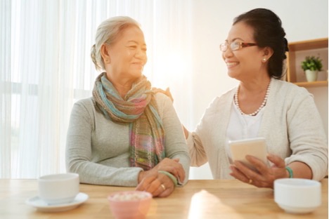 Woman sitting with her mother at a table