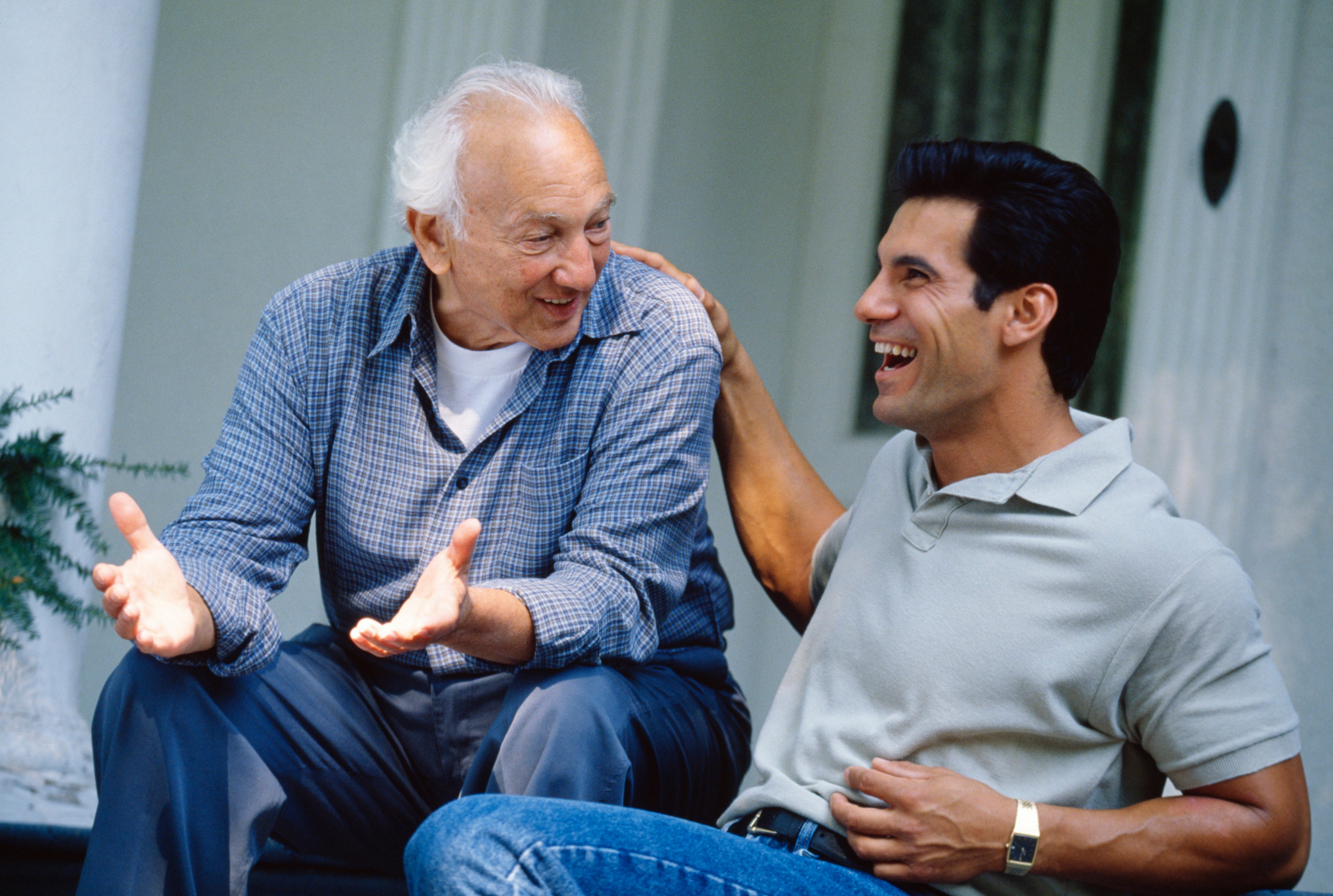 Father talking to his son on the front steps of their house