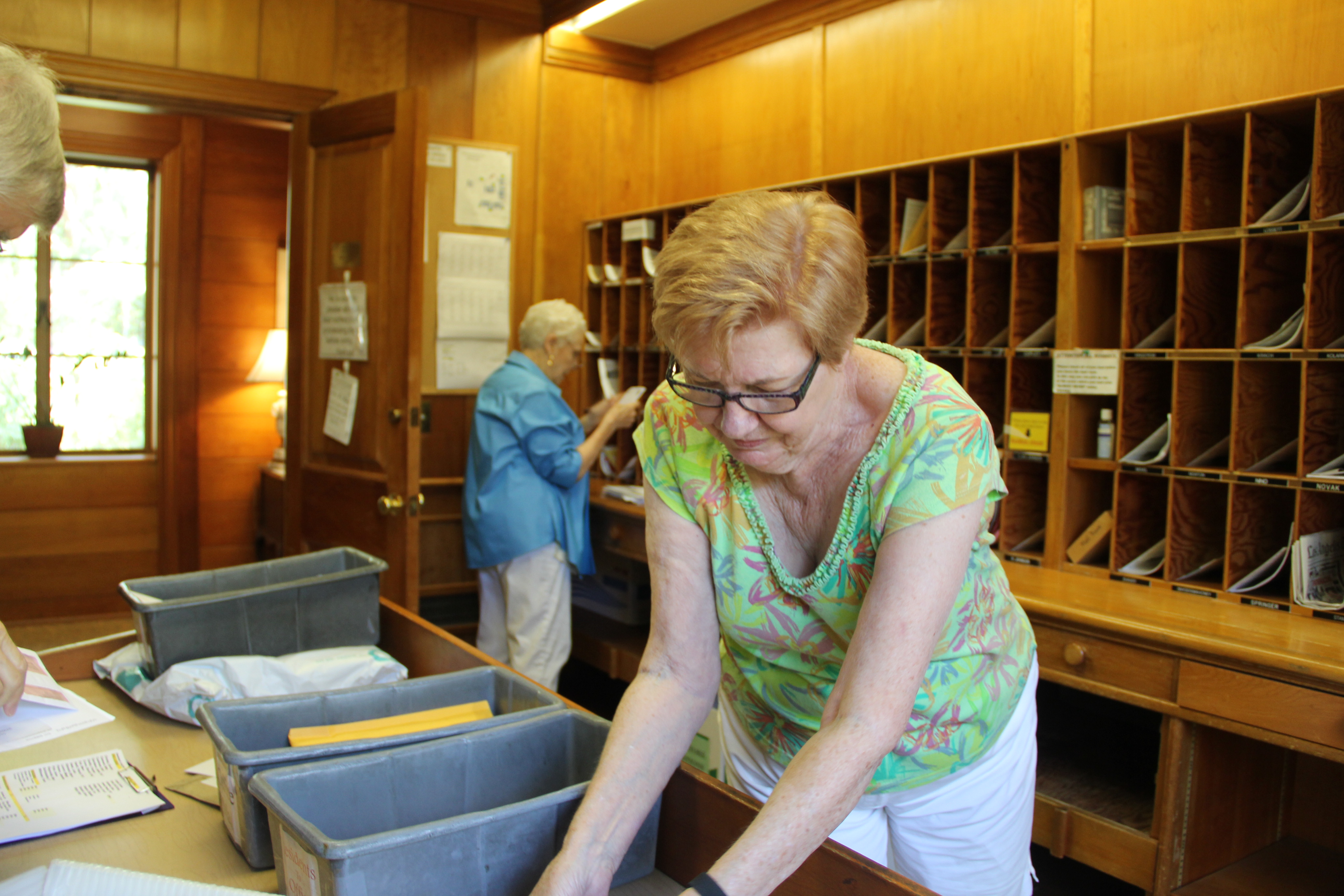 Two people sorting mail together