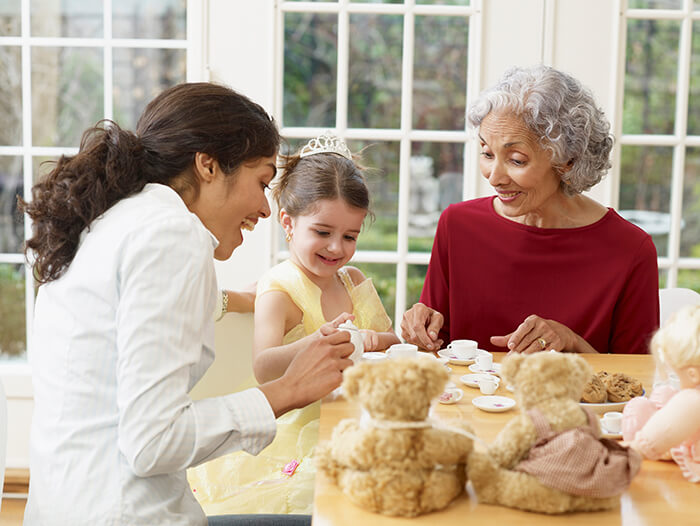 Grandmother, mother, and daughter having a tea party