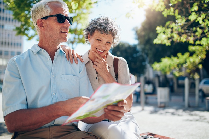 A couple walking around with a map together.