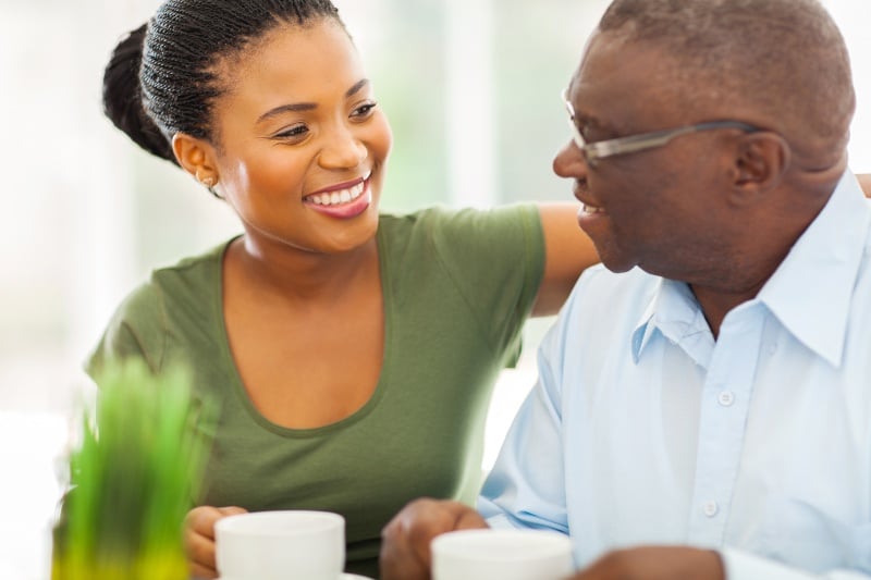 Senior dad drinking coffee with daughter