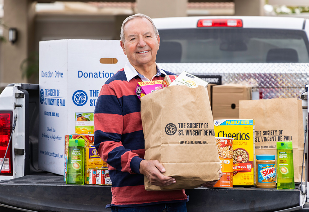 senior man holding donation bags