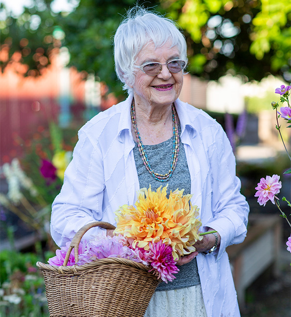 Doris holding a basket of fresh cut flowers