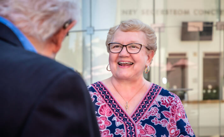 Smiling senior woman talking to a senior man