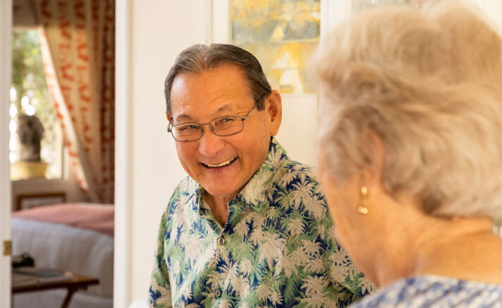 Senior man smiling at a senior woman