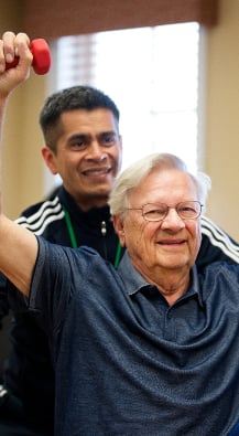 Man exercising with personal trainer. 