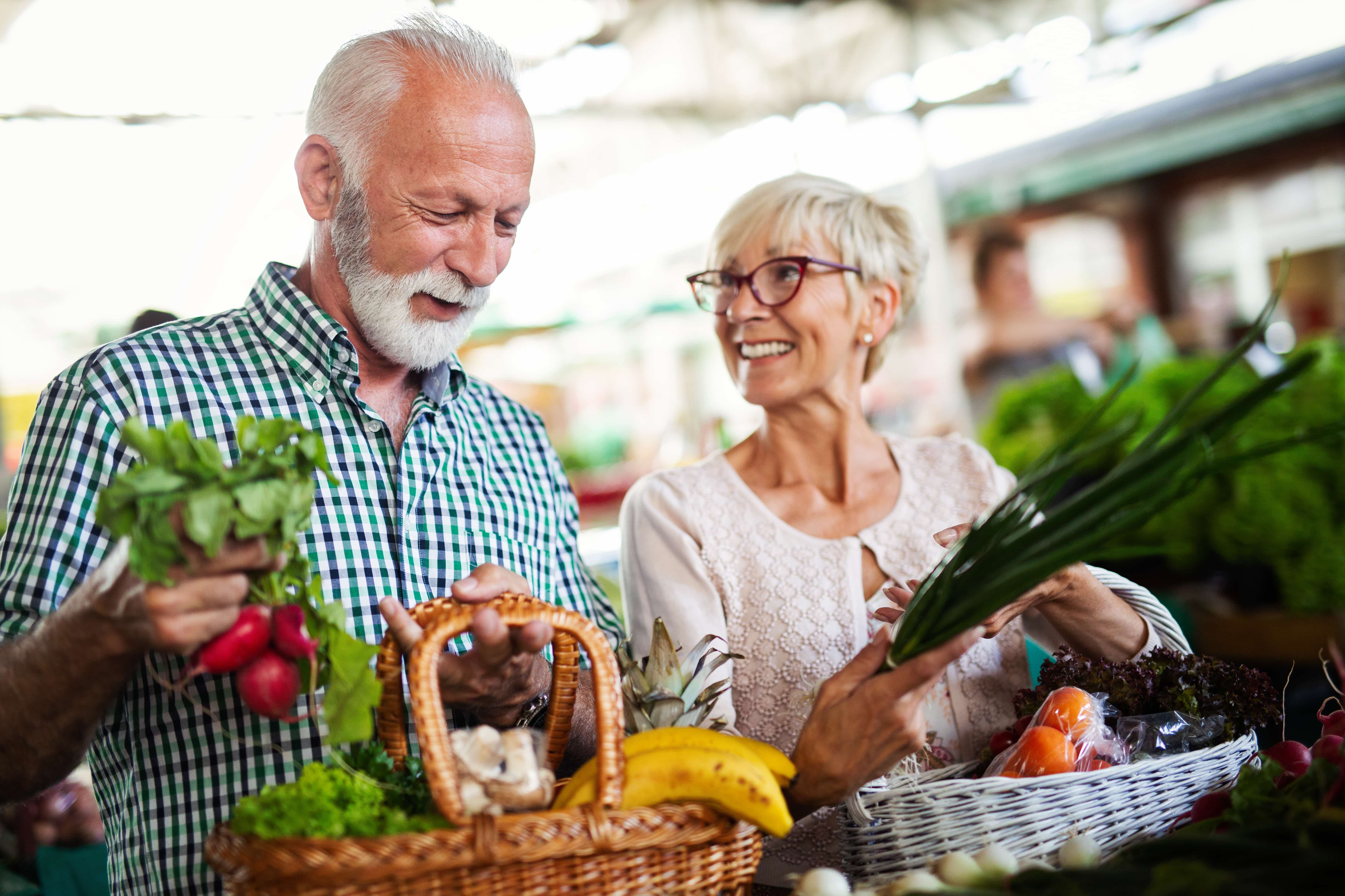 Two HumanGood residents shopping for heart healthy produce at a grocery store