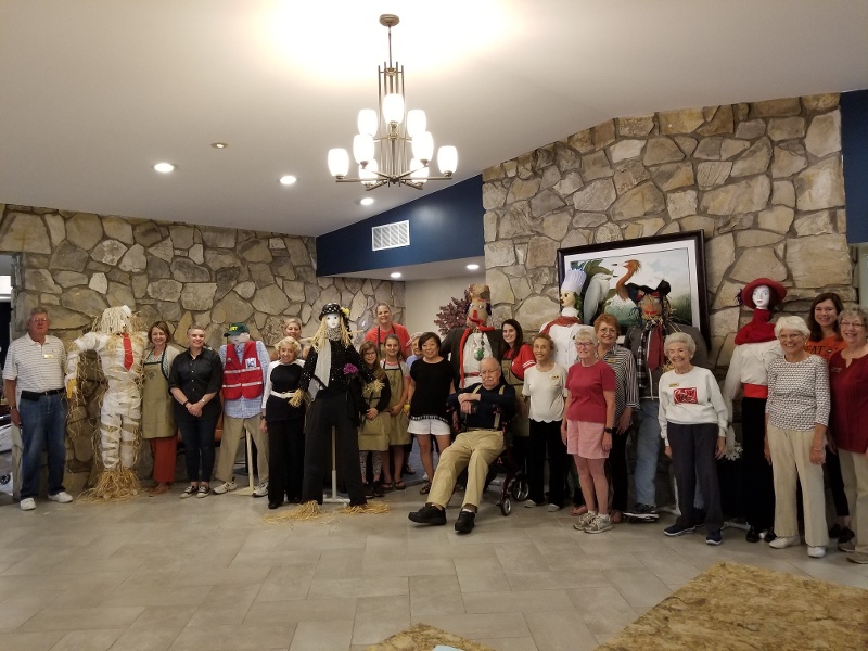 Royal Oaks residents posing with their finished scarecrows.